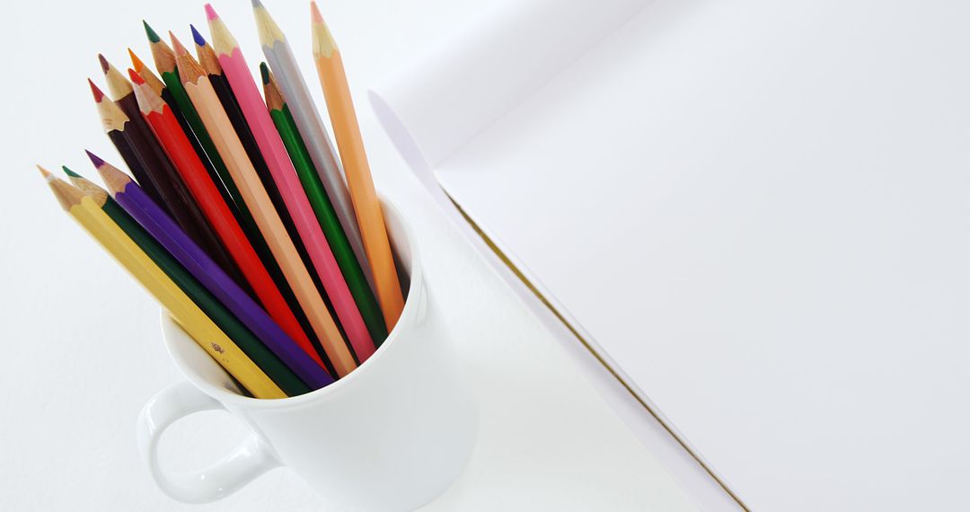 Colorful Pencils in Mug with Open Blank Notebook - Free Images, Stock Photos and Pictures on Pikwizard.com