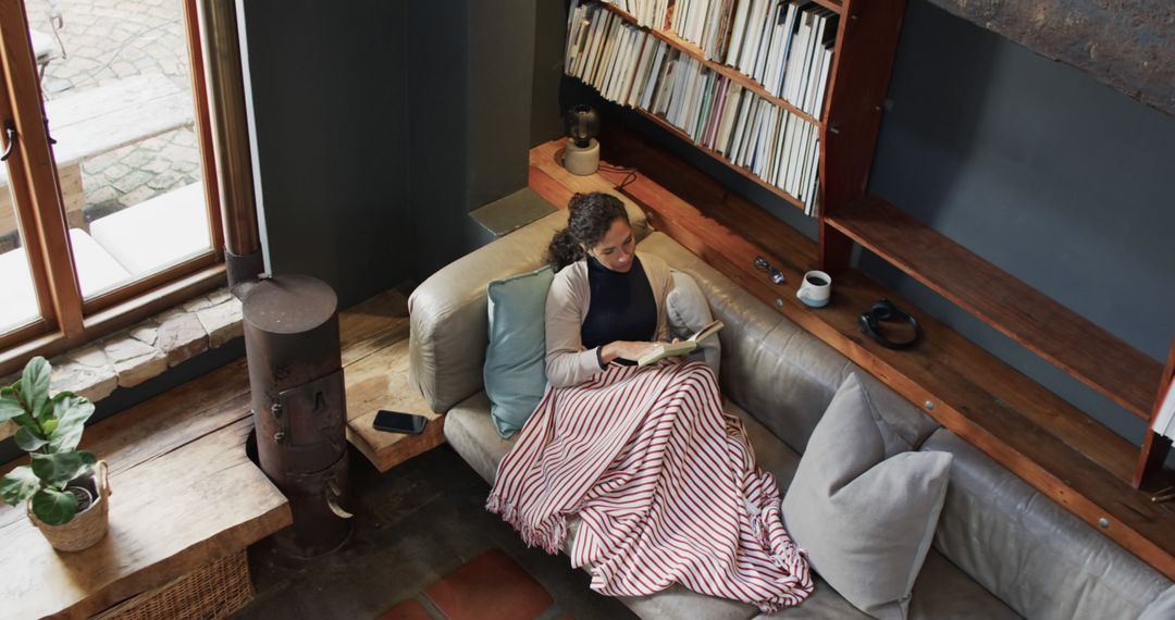 Woman Reading Book on Couch in Cozy Living Room - Free Images, Stock Photos and Pictures on Pikwizard.com