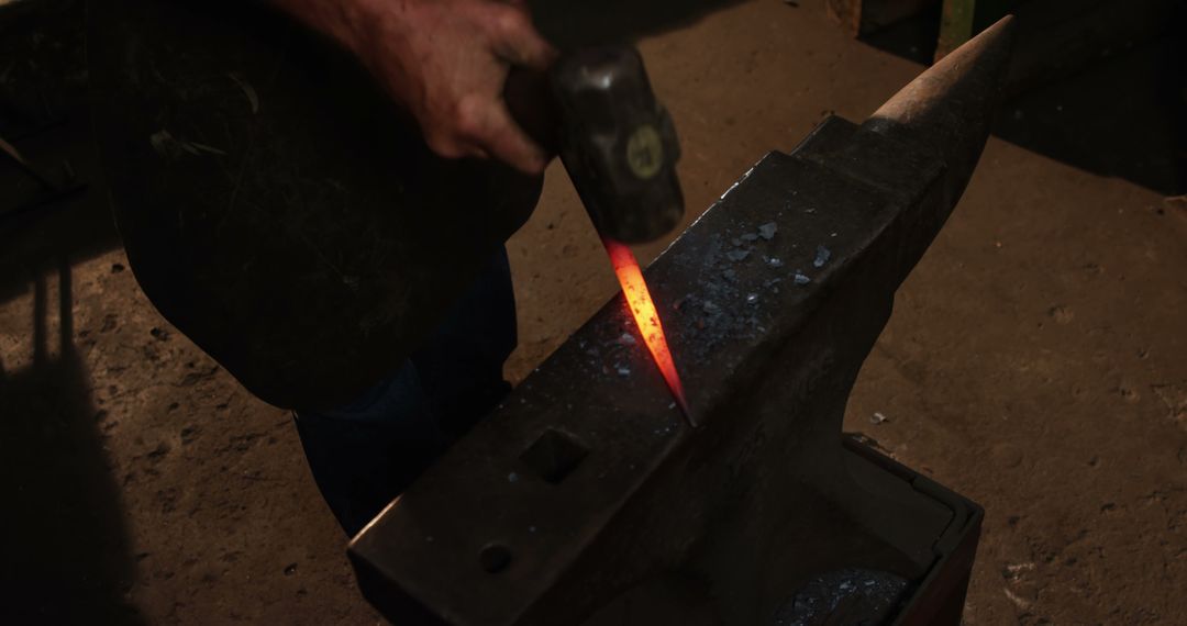 Blacksmith Forging Hot Metal in Dark Workshop - Free Images, Stock Photos and Pictures on Pikwizard.com