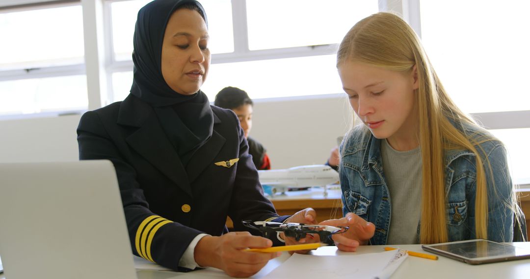 Female Pilot Teaching Student About Drone Technology in Classroom - Free Images, Stock Photos and Pictures on Pikwizard.com