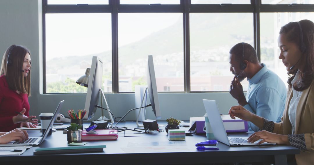 Diverse Office Team Working with Laptops and Headsets