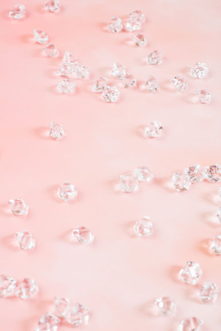 Scattered Clear Crystals on Soft Pink Background