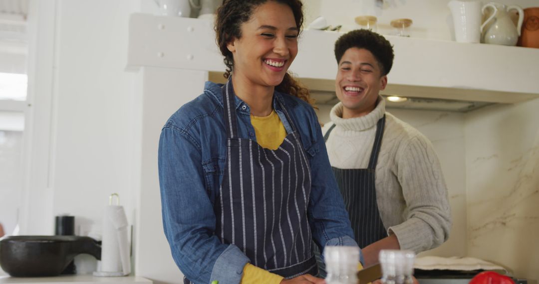 Image of happy biracial couple preparing meal together - Free Images, Stock Photos and Pictures on Pikwizard.com