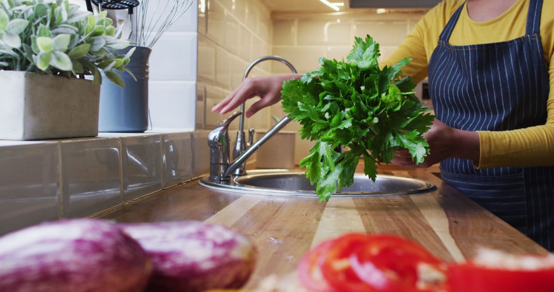 Person Washes Fresh Vegetables in Modern Kitchen - Free Images, Stock Photos and Pictures on Pikwizard.com