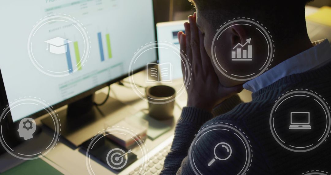 Focused professional analyzing data charts on monitor with digital analytics icons overlay