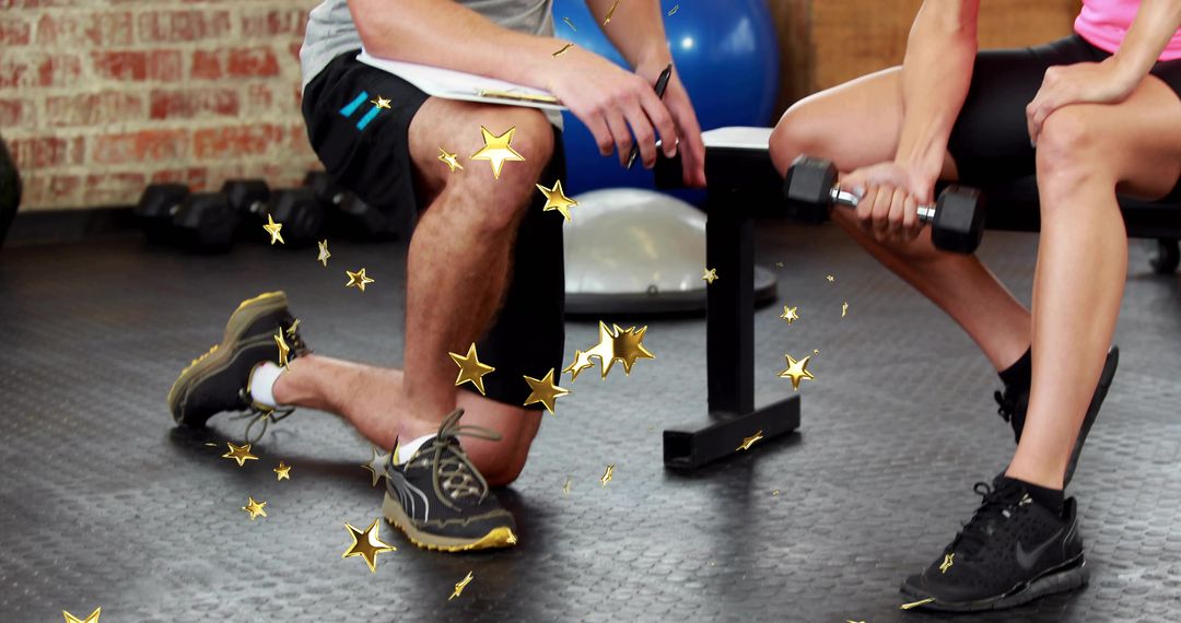 Kneeling personal trainer coaching client lifting dumbbell on bench for strength training