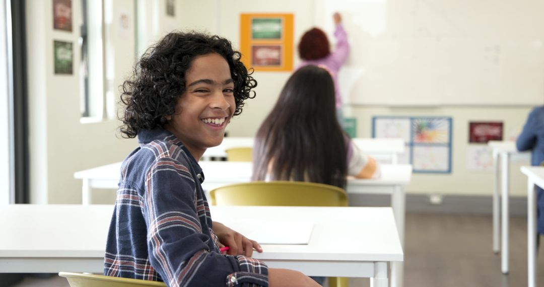 Smiling Student with Teacher in Classroom During Lesson