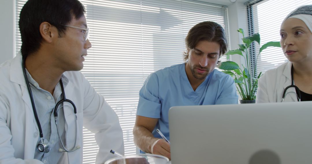 Multicultural Medical Team Collaborating in Modern Office - Free Images, Stock Photos and Pictures on Pikwizard.com