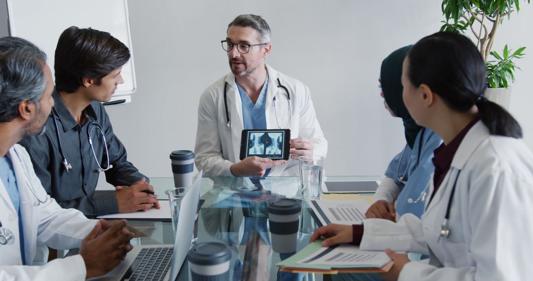 Doctors Discussing Medical X-Rays in Professional Meeting - Free Images, Stock Photos and Pictures on Pikwizard.com