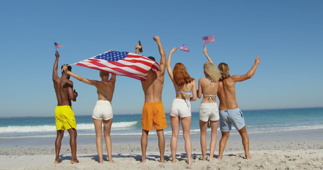 Group of Friends Celebrating Independence Day on Beach - Free Images, Stock Photos and Pictures on Pikwizard.com