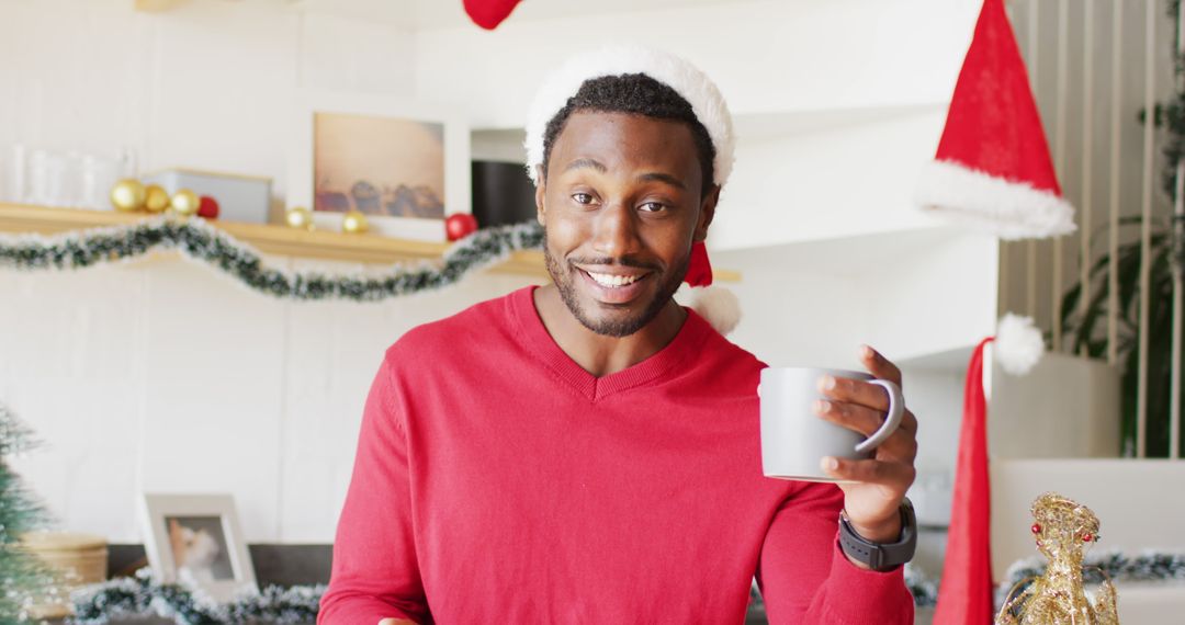 Festive Man Holding Mug in Christmas Themed Kitchen - Free Images, Stock Photos and Pictures on Pikwizard.com