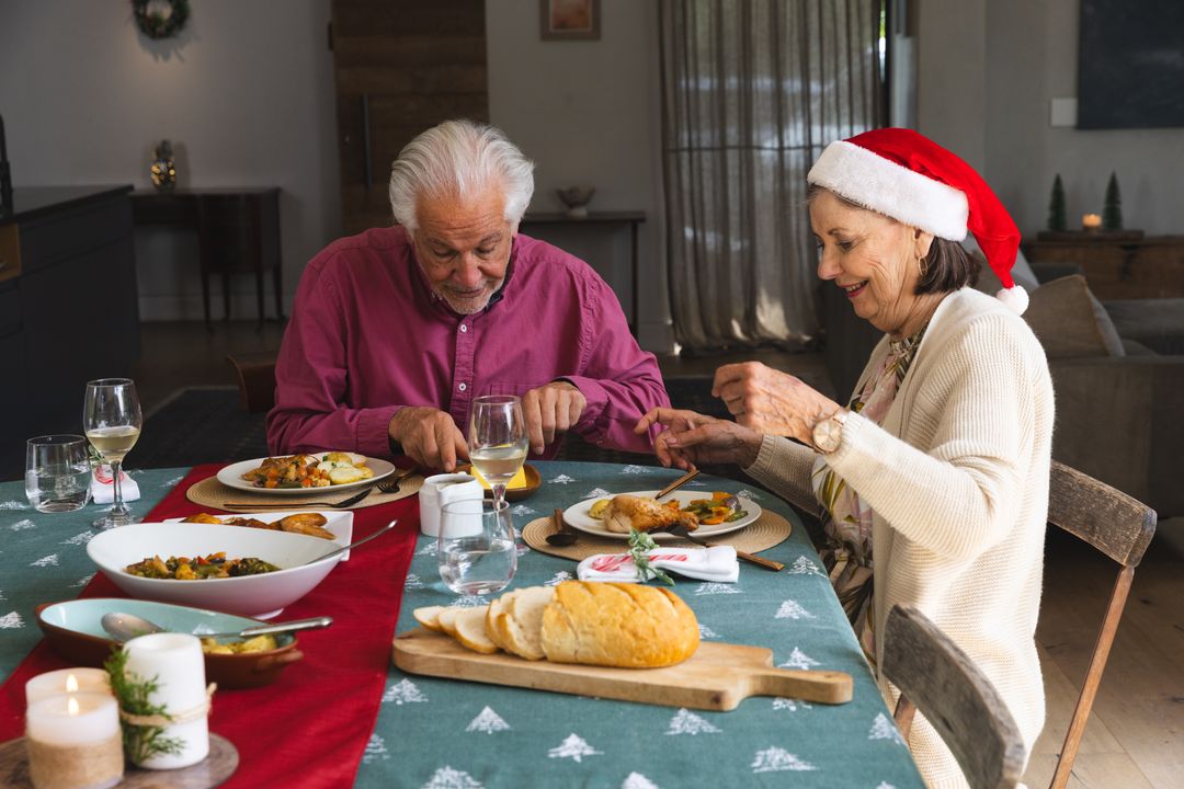 Senior Couple Enjoying Holiday Dinner in Festive Atmosphere