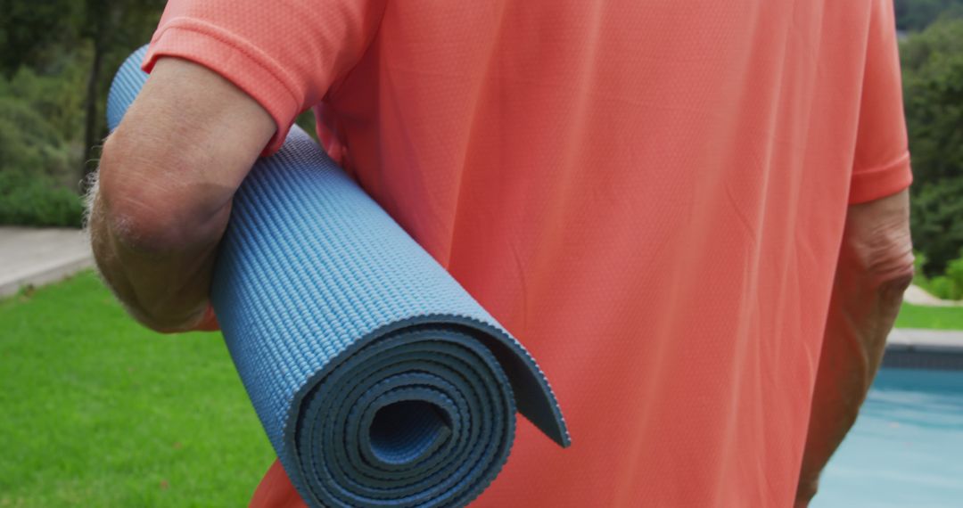 Senior Man Carrying Yoga Mat in Outdoor Setting - Free Images, Stock Photos and Pictures on Pikwizard.com