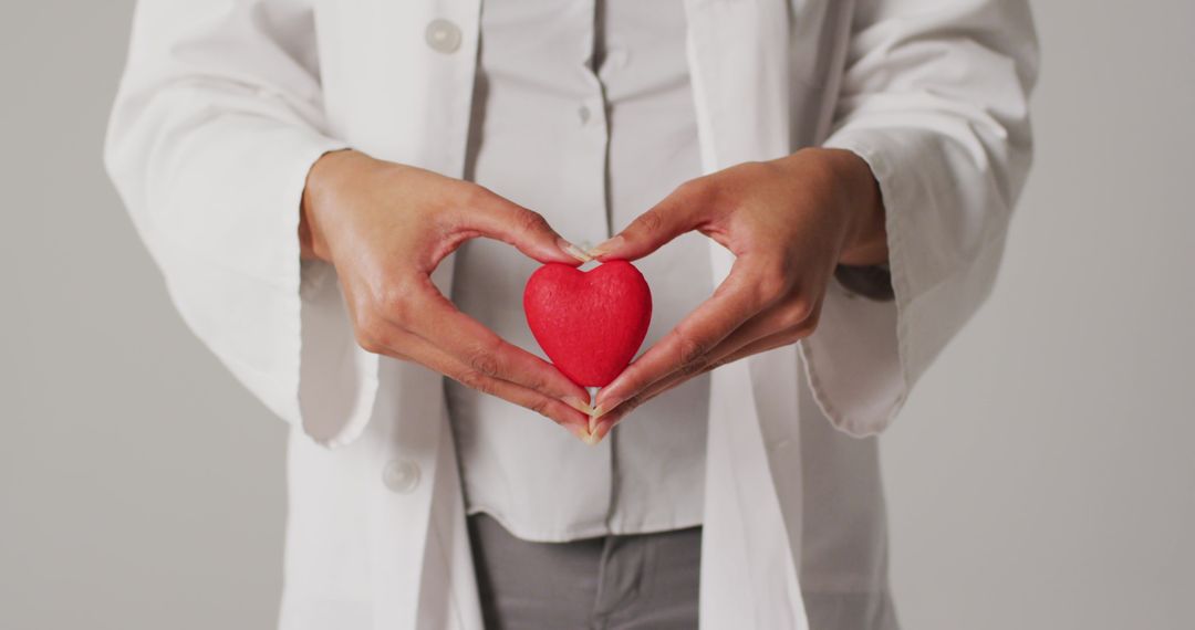 Doctor Holding Heart Shaped Object Symbolizing Healthcare and Compassion - Free Images, Stock Photos and Pictures on Pikwizard.com