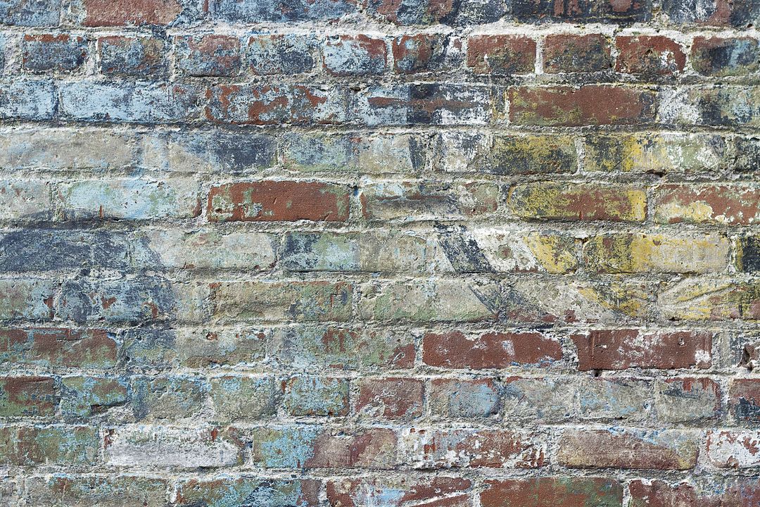 Aged Colorful Brick Wall with Weathered Texture - Free Images, Stock Photos and Pictures on Pikwizard.com