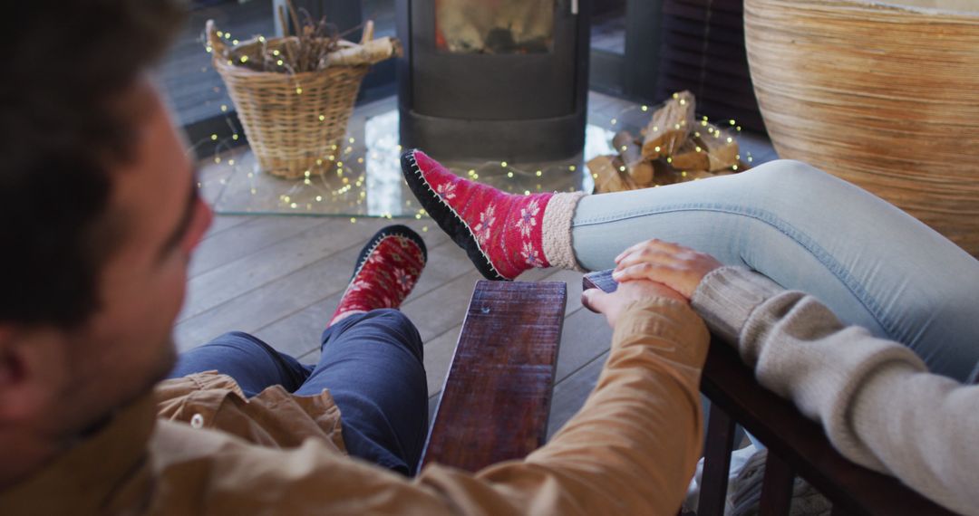 Cozy Couple Relaxing by Fireplace in Winter Socks - Free Images, Stock Photos and Pictures on Pikwizard.com