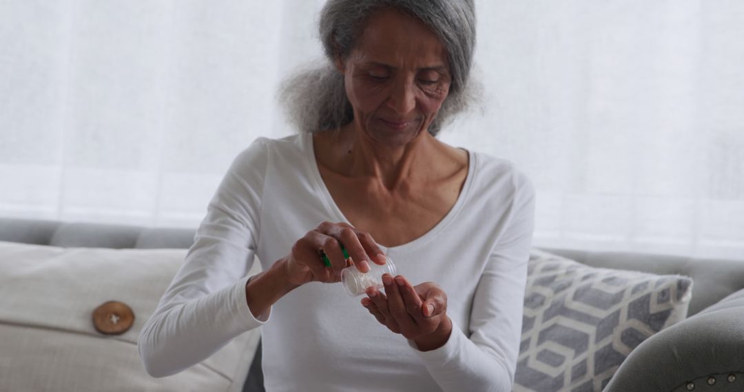 Senior Woman Using Hand Sanitizer at Home - Free Images, Stock Photos and Pictures on Pikwizard.com