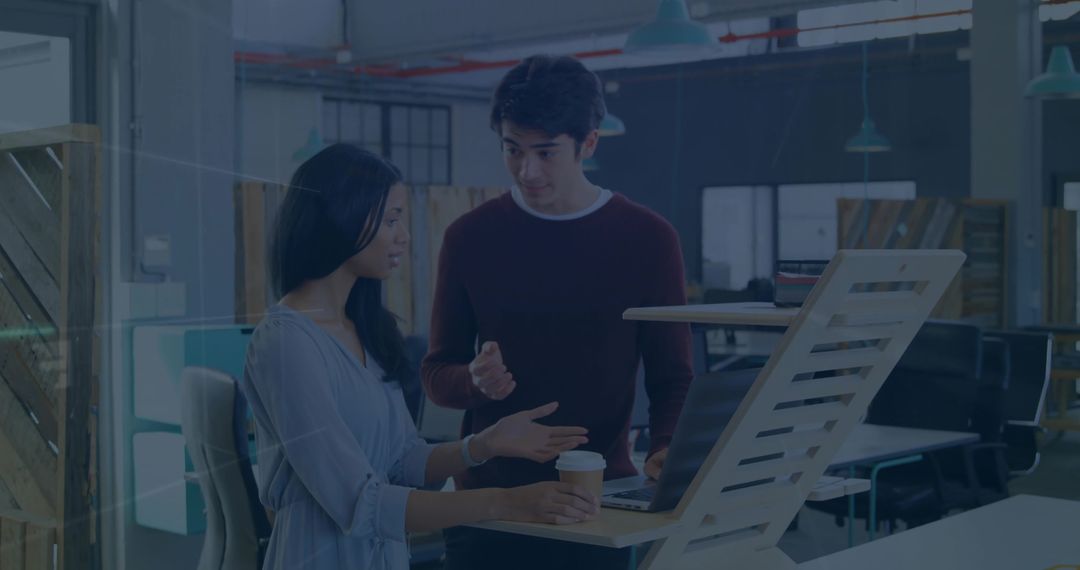 Colleagues Engaged in Discussion at Modern Office Workspace