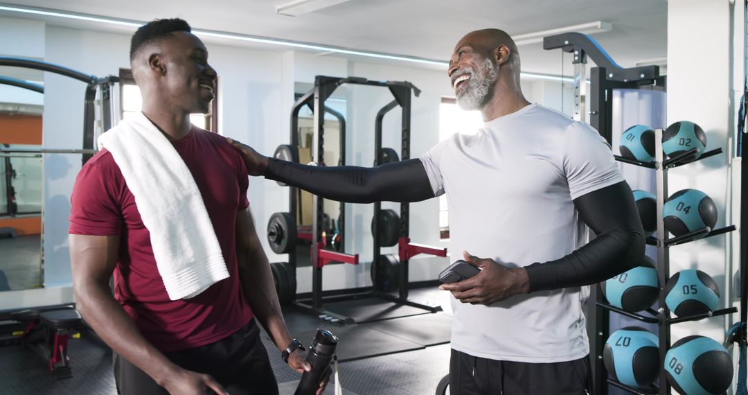 Personal Trainer Encouraging Client at Modern Gym Facility