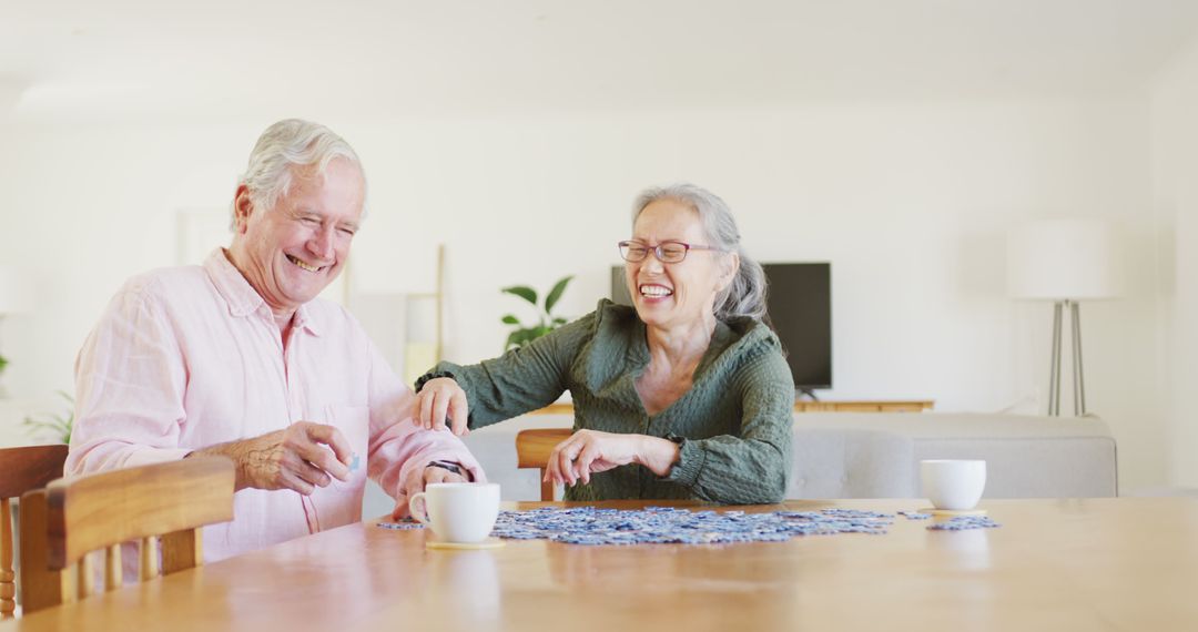 Joyful Elderly Couple Solving Puzzle at Home