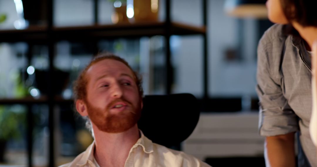 Colleagues Collaborating in Modern Office for Late-Night Project