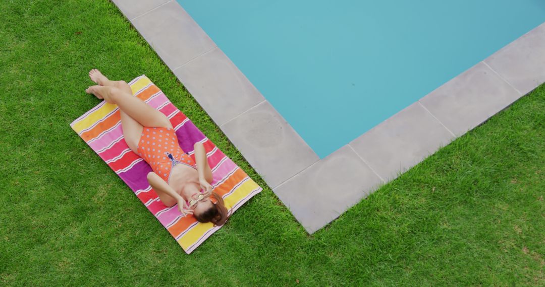 Woman Relaxing by Poolside Enjoying Sunny Day in Garden - Free Images, Stock Photos and Pictures on Pikwizard.com