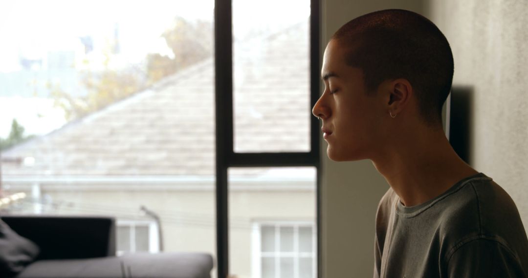 Person Practicing Mindfulness Meditation Indoors by Window - Free Images, Stock Photos and Pictures on Pikwizard.com