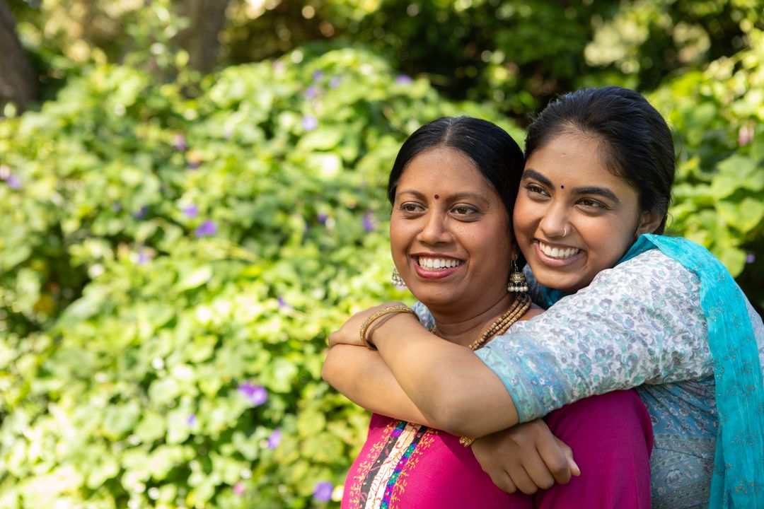 Mother and Daughter Smiling Together in Tranquil Garden