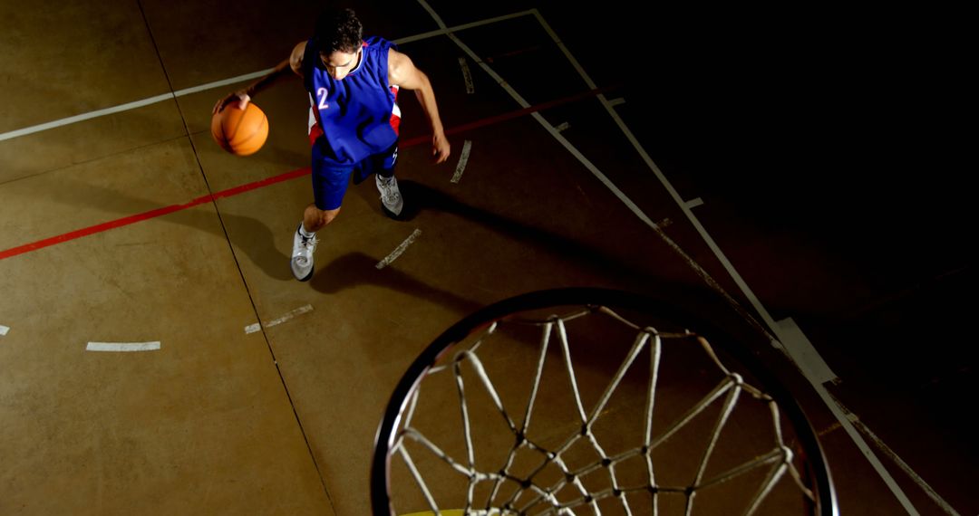 Basketball Player Dribbling on Court During Night Game - Free Images, Stock Photos and Pictures on Pikwizard.com