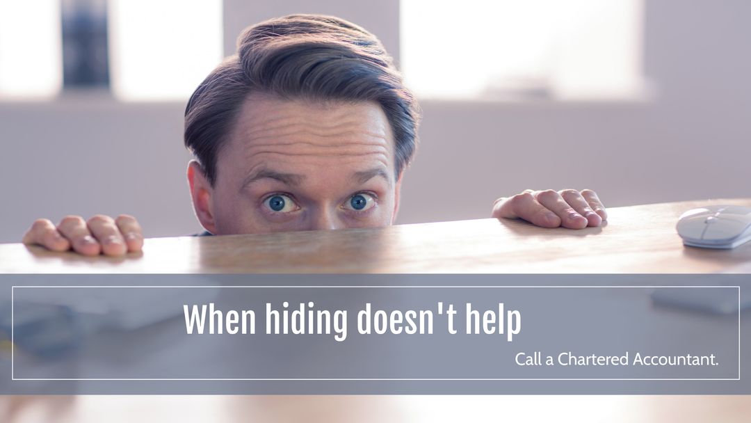 Man Peeking Over Desk for Financial Assistance Awareness