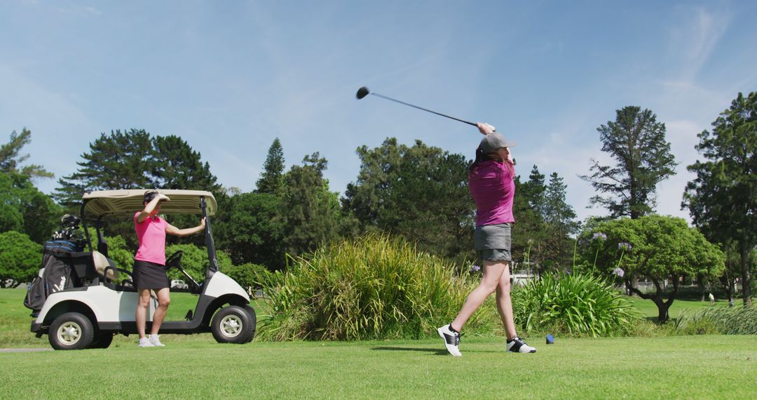 Two Women Playing Golf on a Bright Sunny Day - Free Images, Stock Photos and Pictures on Pikwizard.com