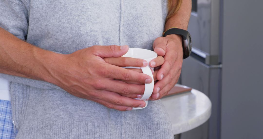 Hands Holding Coffee Mug in Relaxed Home Environment