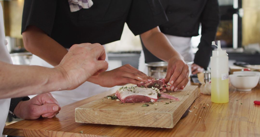 Chefs Preparing Meat with Seasoning on Wooden Board - Free Images, Stock Photos and Pictures on Pikwizard.com