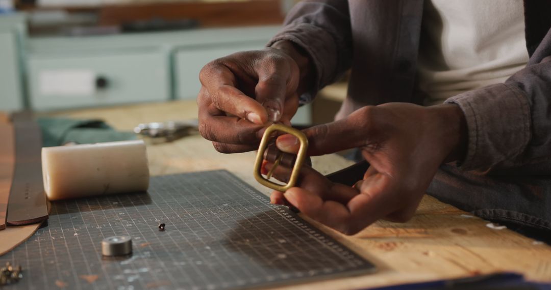 Close-Up of Craftsman Polishing Belt Buckle in Workshop