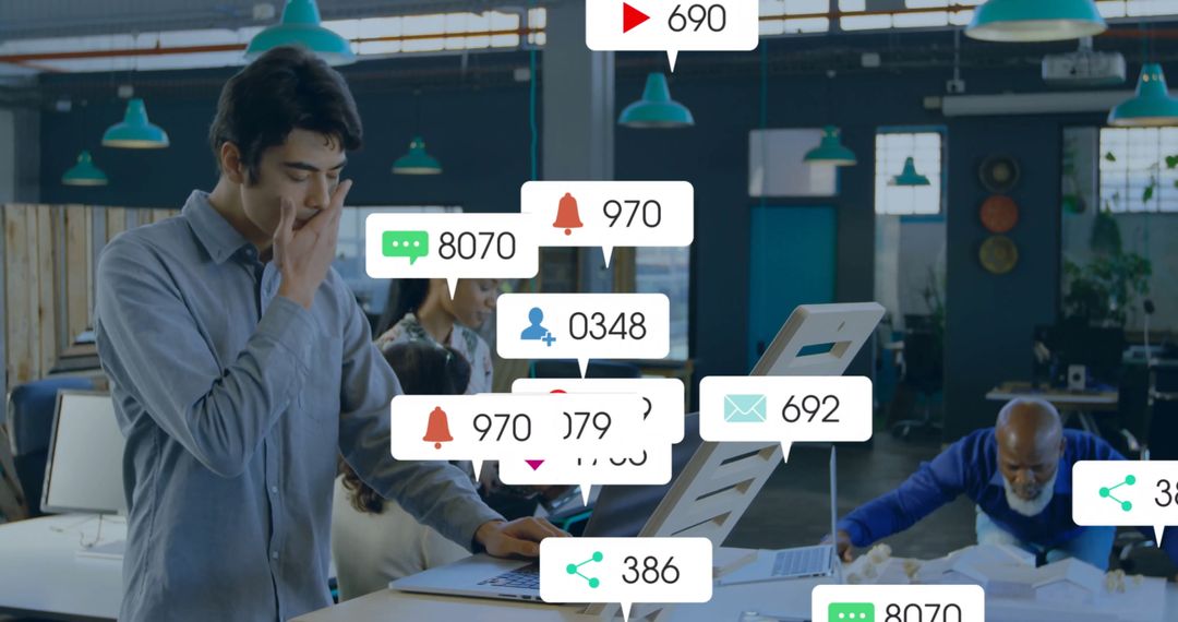 Young Man in Open Office Habituated by Technology and Notifications