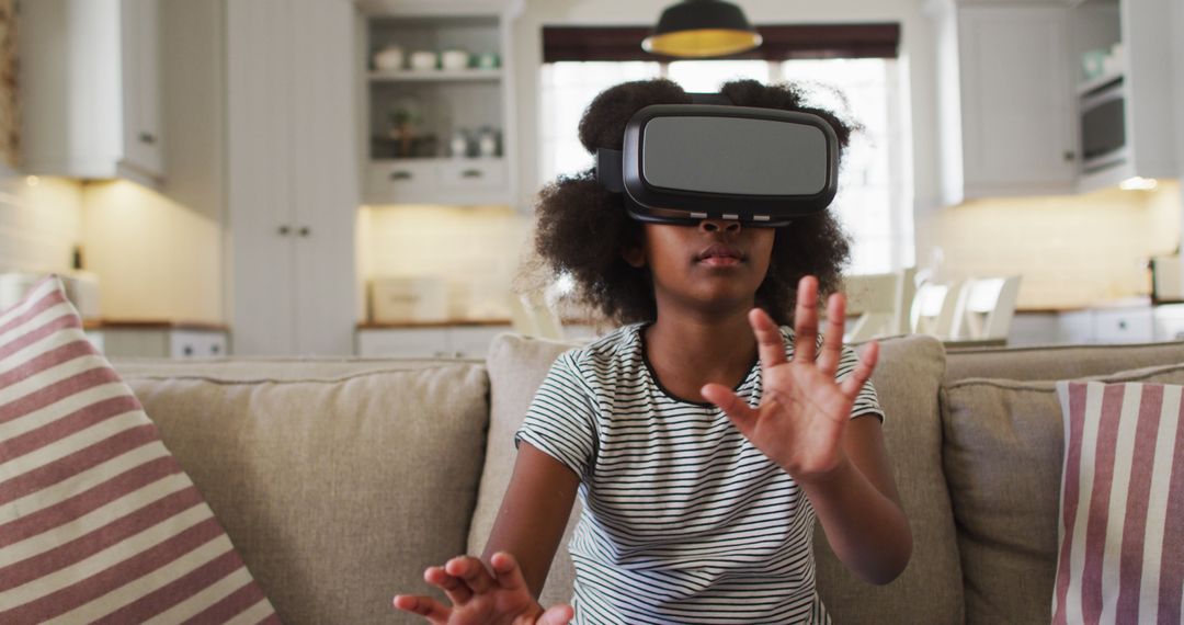 Young Girl Using Virtual Reality Headset in Living Room - Free Images, Stock Photos and Pictures on Pikwizard.com