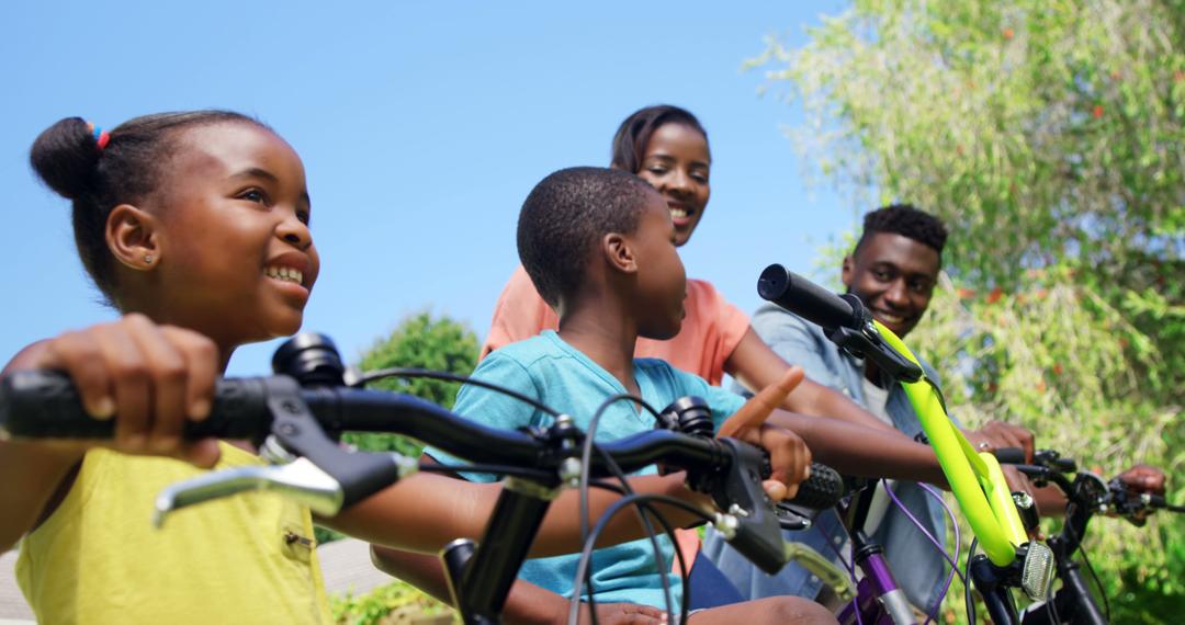 Happy African American Family Riding Bicycles Outdoors on a Sunny Day - Free Images, Stock Photos and Pictures on Pikwizard.com