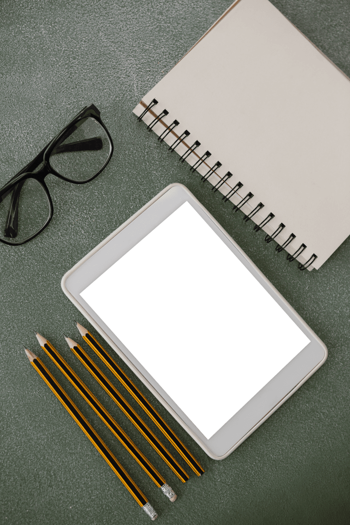 Transparent Tablet on Chalkboard with Office Supplies