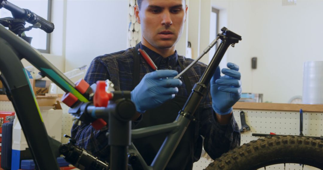 Mechanic Skillfully Repairing Bicycle Frame in Workshop