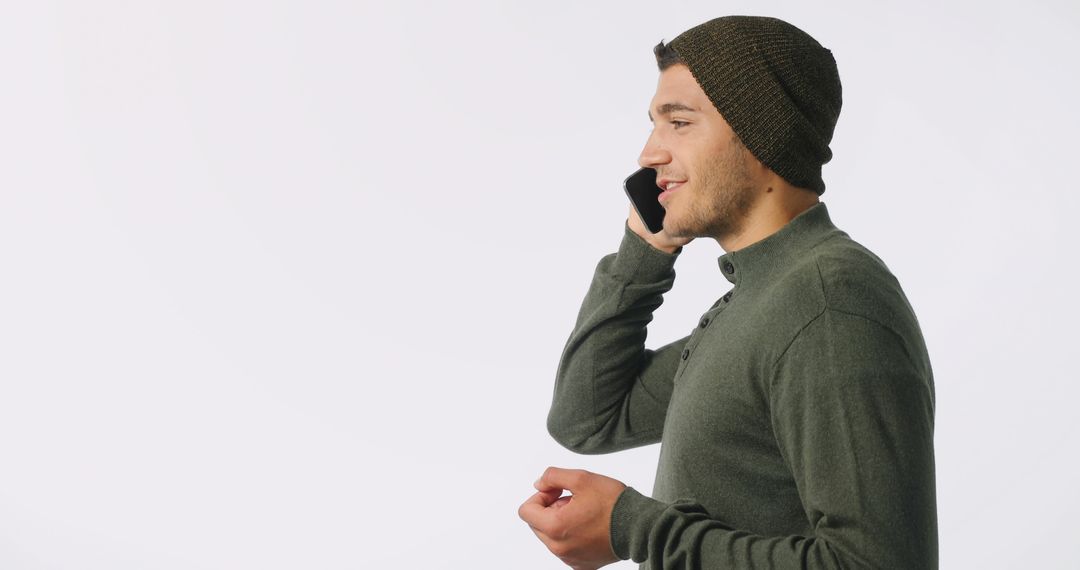 Man in Beanie Speaking on Smartphone with Copy Space