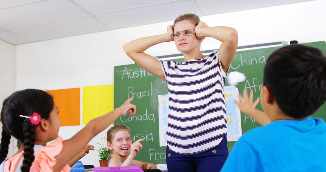 Frustrated Teacher Standing in Classroom with Disruptive Students - Free Images, Stock Photos and Pictures on Pikwizard.com