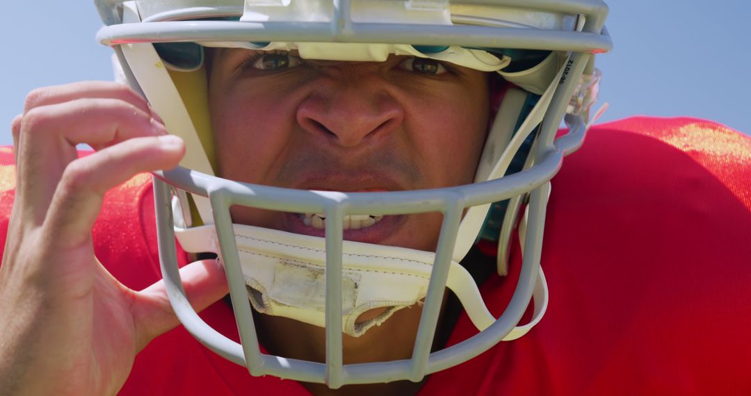 Close-Up of Determined American Football Player in Red Jersey Looking at Camera - Free Images, Stock Photos and Pictures on Pikwizard.com