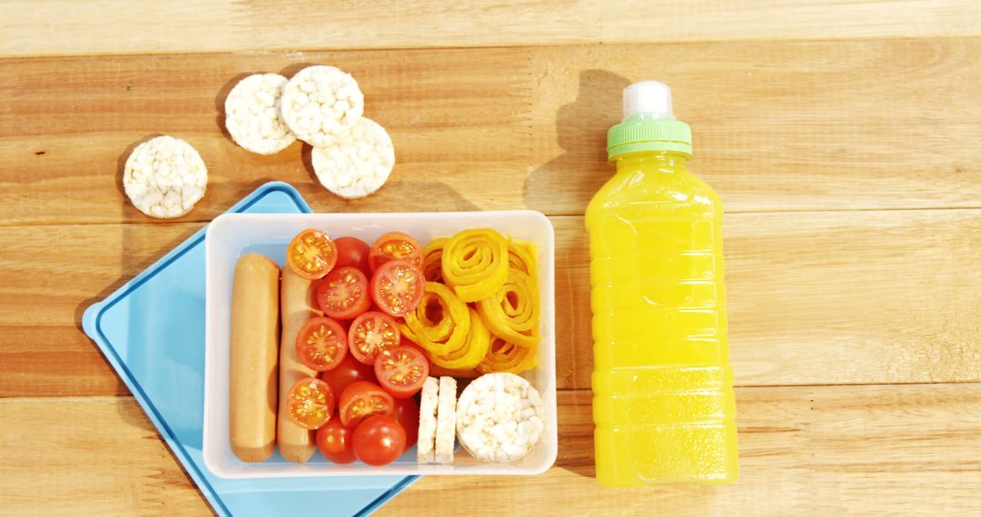 Close-up of tomatoes with sweet food and juice bottle on a table 4k - Free Images, Stock Photos and Pictures on Pikwizard.com