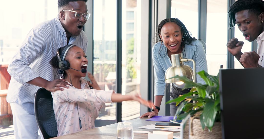 Diverse Team Celebrating Success at Workplace with Joy and Excitement
