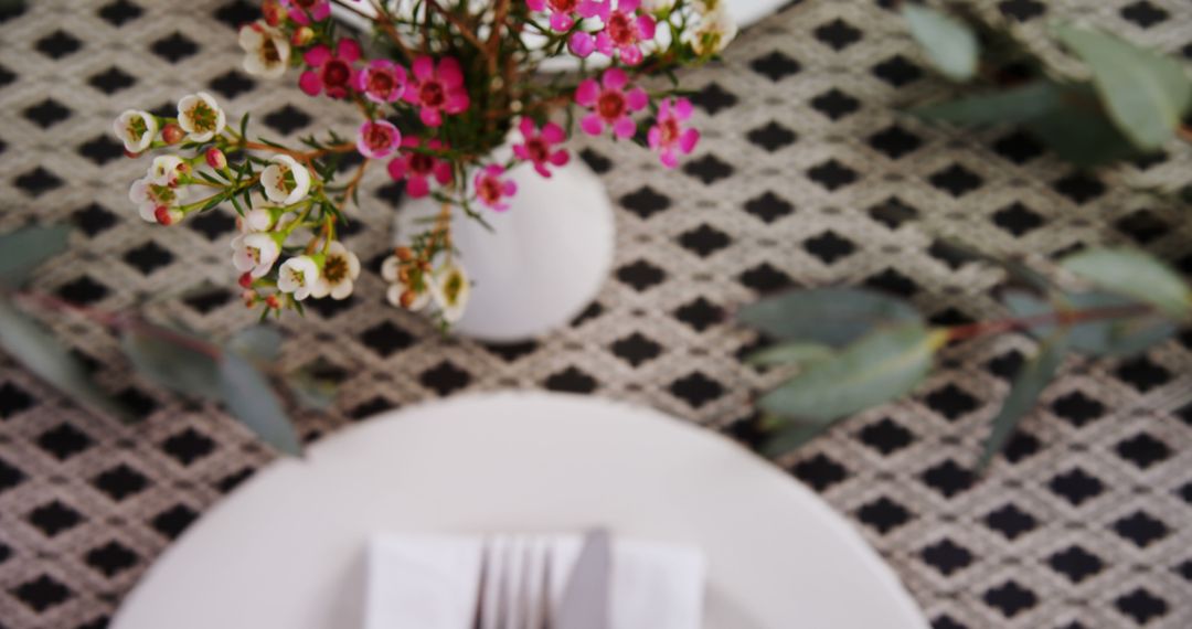 Elegant Tabletop Arrangement with Flowers and Cutlery
