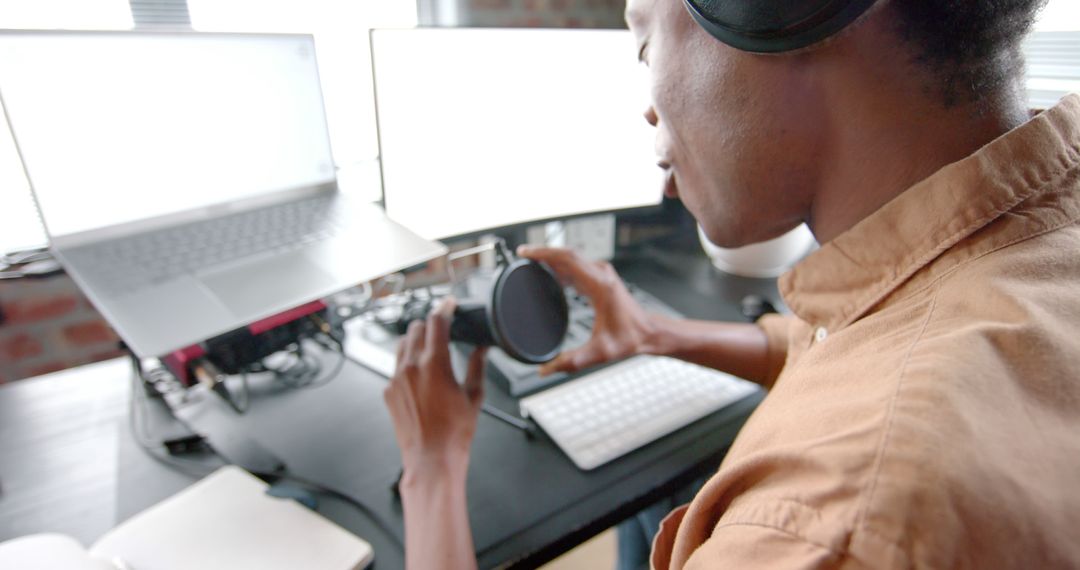 Young Man with Headphones Using Smart Speaker at Desk - Free Images, Stock Photos and Pictures on Pikwizard.com