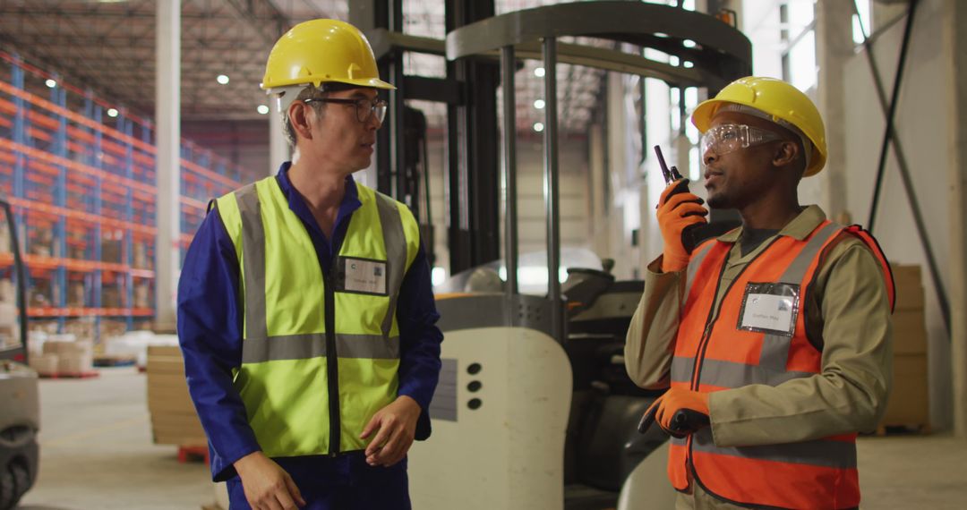 Warehouse Workers Communicating in Industrial Facility - Free Images, Stock Photos and Pictures on Pikwizard.com