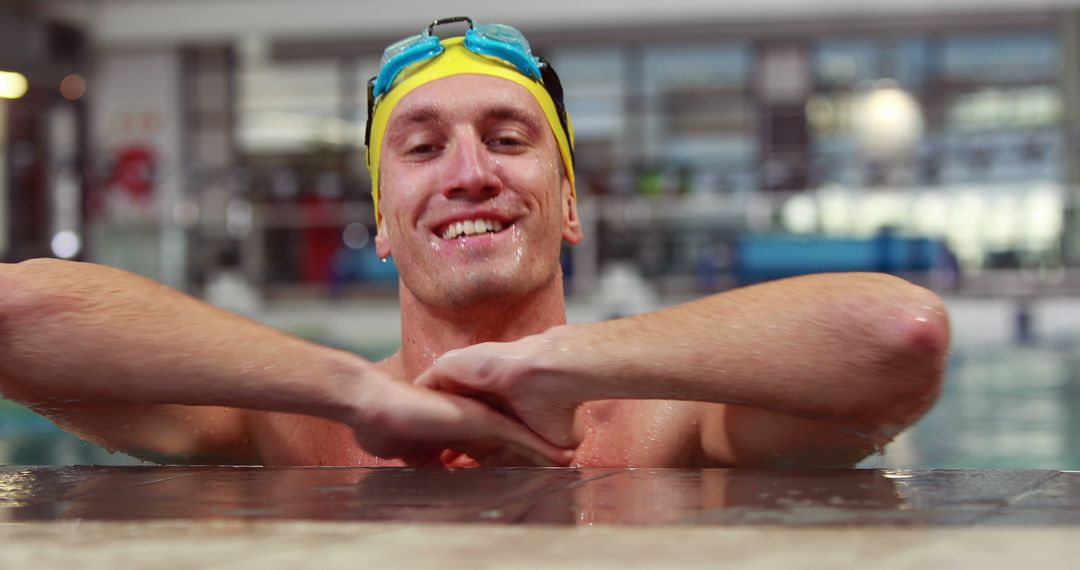 Swimmer Resting at Pool Edge with Yellow Cap and Goggles - Free Images, Stock Photos and Pictures on Pikwizard.com