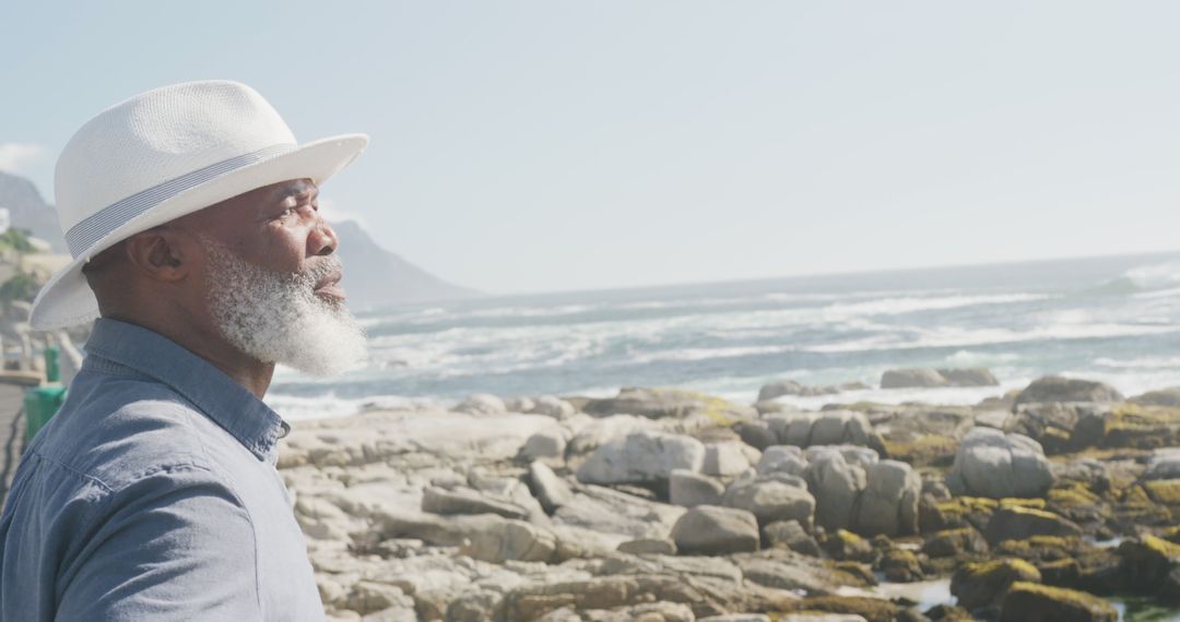 Senior Man with White Beard and Hat Enjoying Seaside View - Free Images, Stock Photos and Pictures on Pikwizard.com