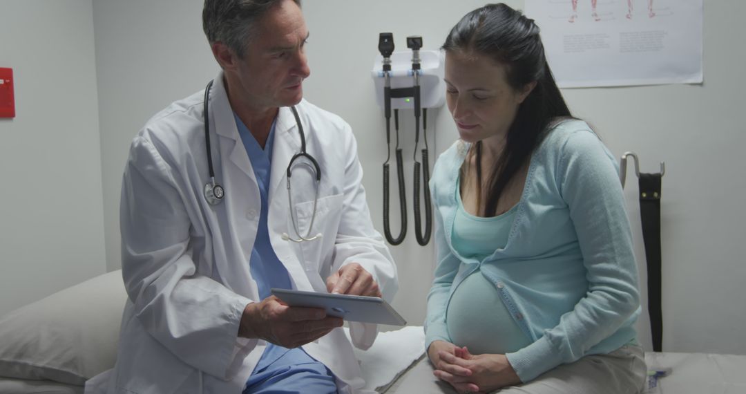 Doctor Consulting Pregnant Woman in Medical Clinic - Free Images, Stock Photos and Pictures on Pikwizard.com